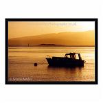 Silhouetted boat against the golden glow of sunset. Oban, Scotland.